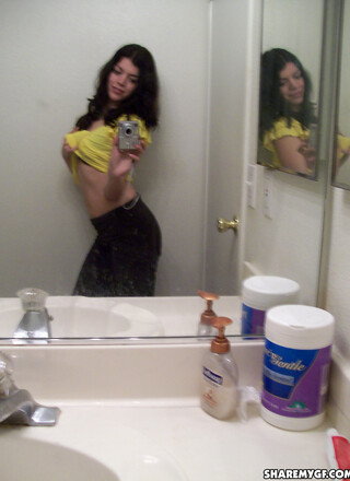 Horny slut takes selfshot pictures in the mirror