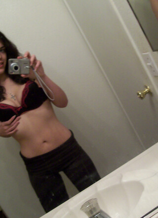 Horny slut takes selfshot pictures in the mirror